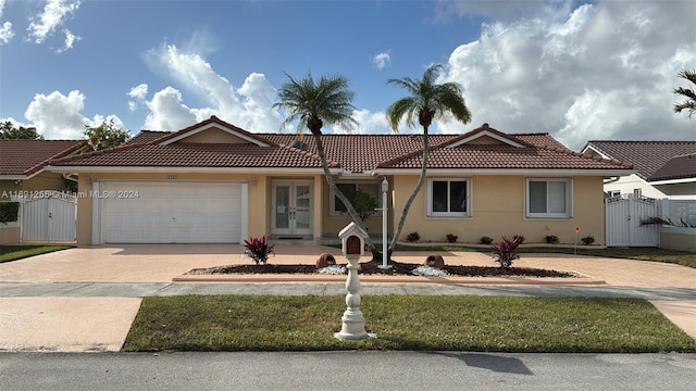 view of front of property with french doors and a garage