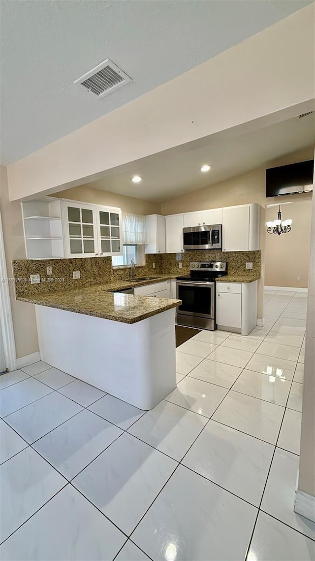 kitchen with kitchen peninsula, white cabinets, stainless steel appliances, and a notable chandelier