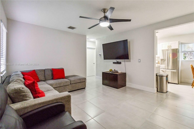 tiled living room with ceiling fan