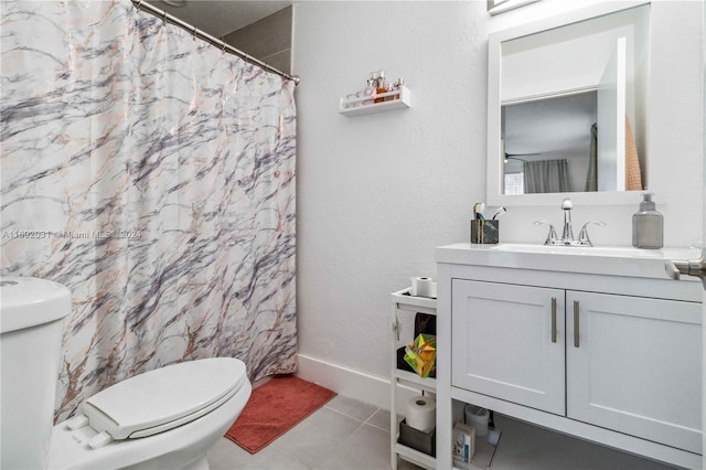 bathroom with tile patterned flooring, vanity, and toilet