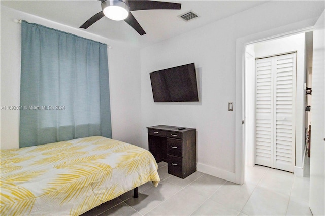 tiled bedroom featuring ceiling fan