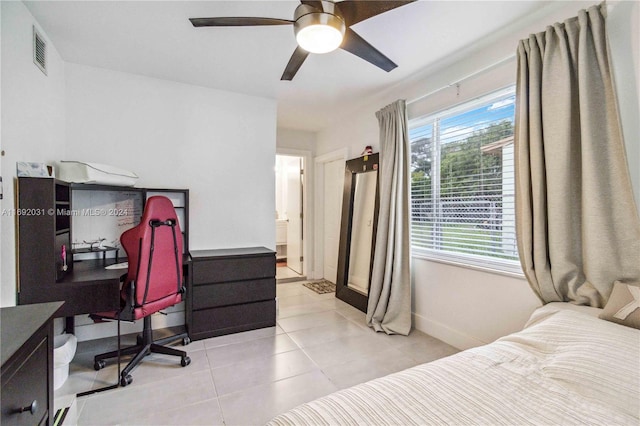 tiled bedroom featuring ceiling fan