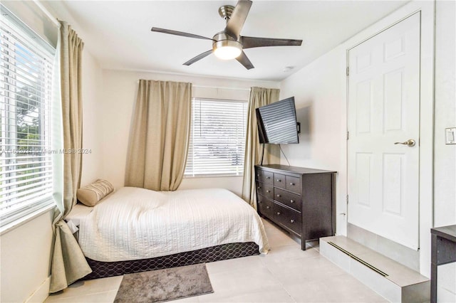 tiled bedroom with ceiling fan