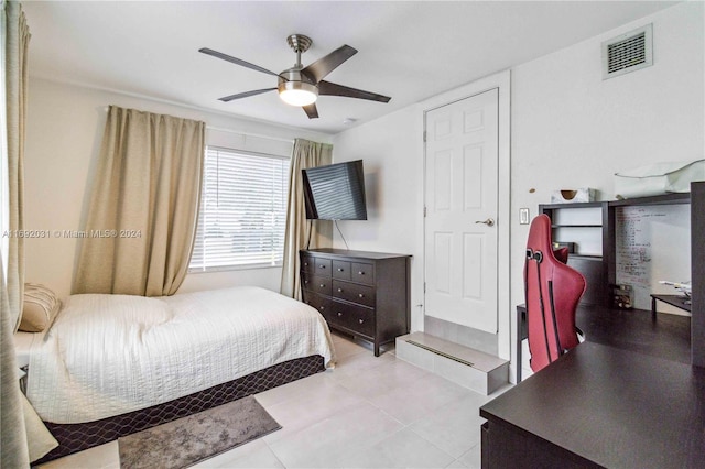 tiled bedroom with ceiling fan