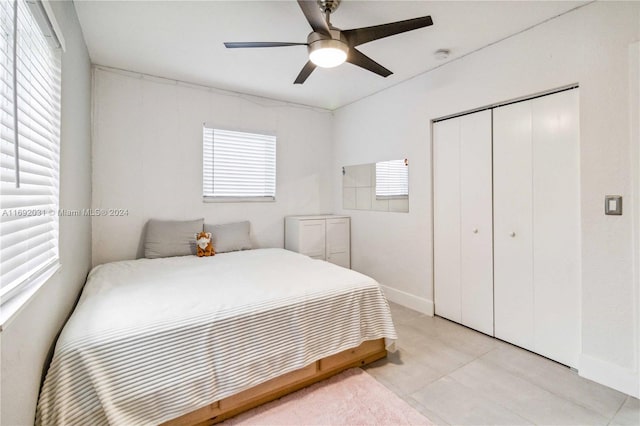 tiled bedroom with a closet and ceiling fan