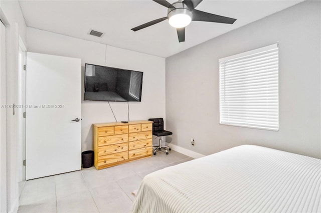 bedroom with ceiling fan and light tile patterned floors