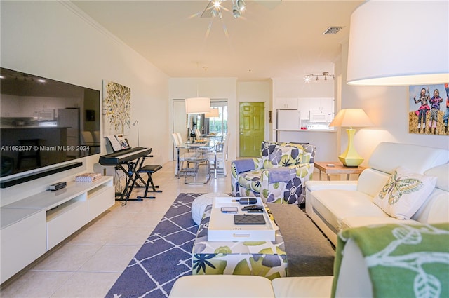 living room featuring light tile patterned floors and ornamental molding