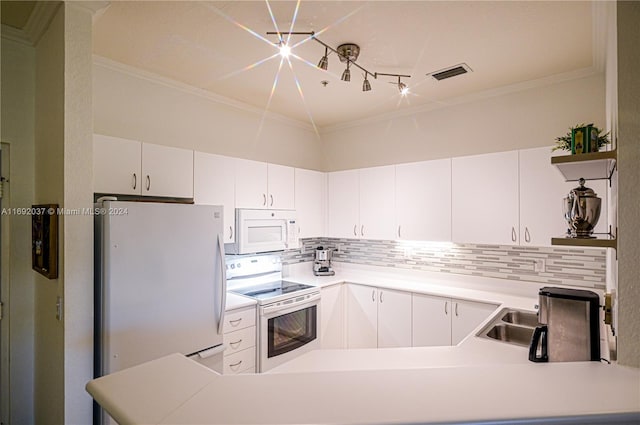 kitchen featuring kitchen peninsula, decorative backsplash, white appliances, and white cabinetry