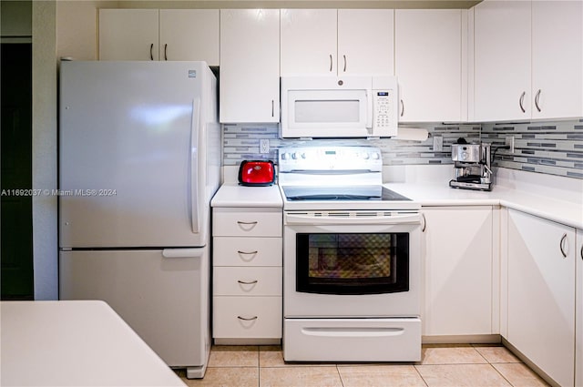 kitchen with white cabinets, light tile patterned floors, white appliances, and tasteful backsplash