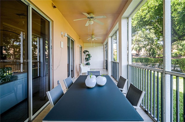 unfurnished sunroom featuring ceiling fan