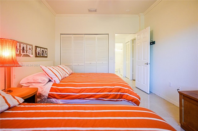 bedroom with ornamental molding and a closet