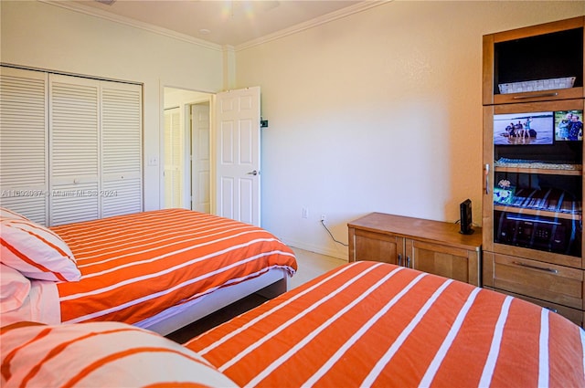 bedroom with a closet and ornamental molding