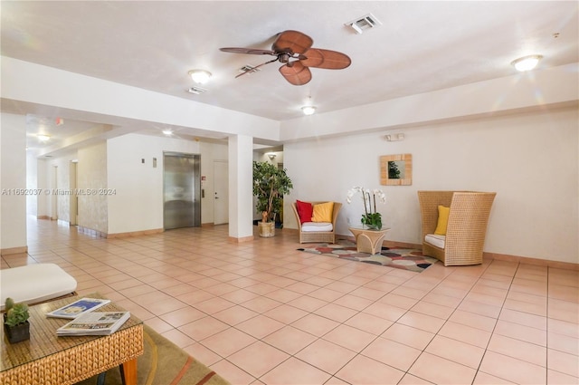 interior space with elevator, ceiling fan, and light tile patterned flooring