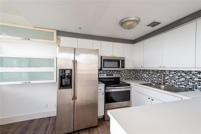 kitchen featuring white cabinetry, sink, dark hardwood / wood-style floors, and appliances with stainless steel finishes