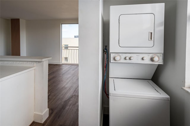 laundry room with stacked washer / dryer and dark wood-type flooring