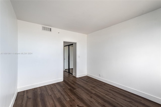 spare room featuring dark hardwood / wood-style flooring