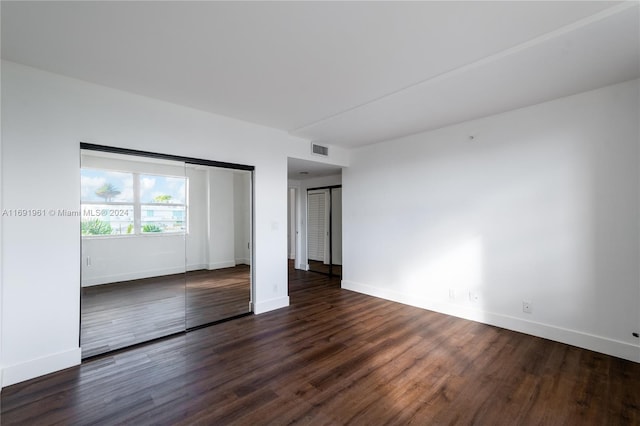 spare room with dark hardwood / wood-style floors