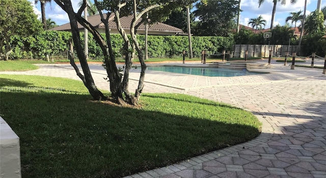 view of pool featuring a lawn