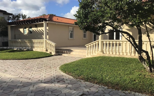 view of property exterior featuring a yard and a porch