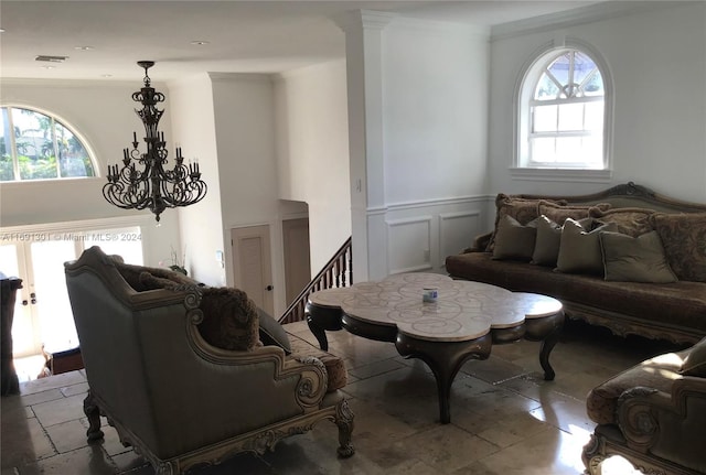 living room featuring crown molding and a chandelier