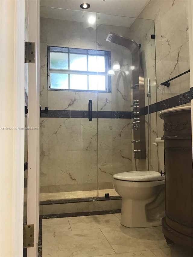 bathroom featuring toilet and walk in shower