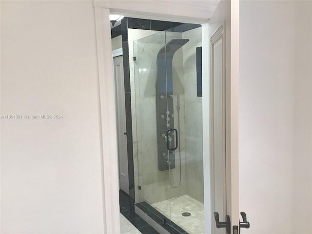 bathroom featuring a shower with shower door