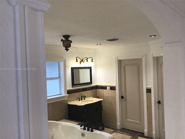 bathroom featuring vanity, tile walls, and ornamental molding