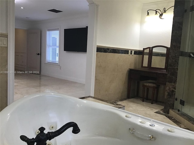 bathroom featuring ornamental molding, tile walls, and a tub