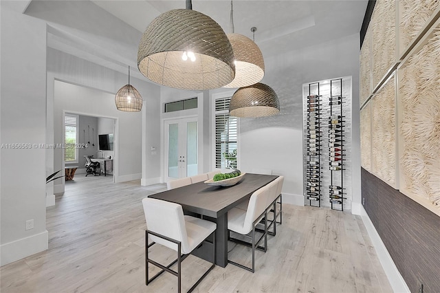 dining room featuring french doors and light hardwood / wood-style flooring