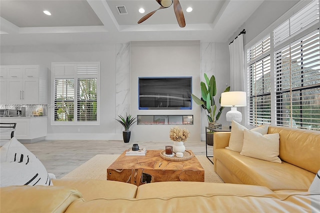 living room featuring light wood-type flooring and ceiling fan