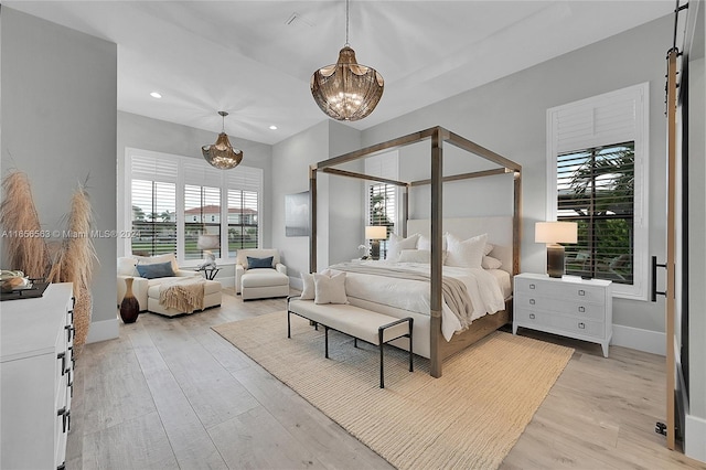 bedroom featuring light hardwood / wood-style flooring and an inviting chandelier