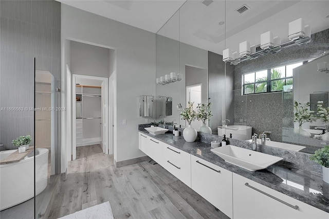 bathroom with tile walls, hardwood / wood-style floors, and vanity