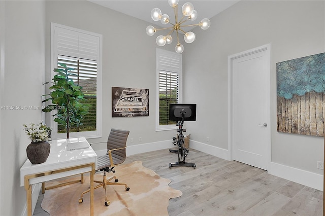 office space with a chandelier and light hardwood / wood-style flooring