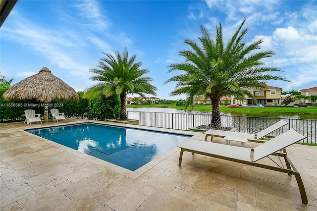 view of swimming pool featuring a patio, a water view, and a gazebo