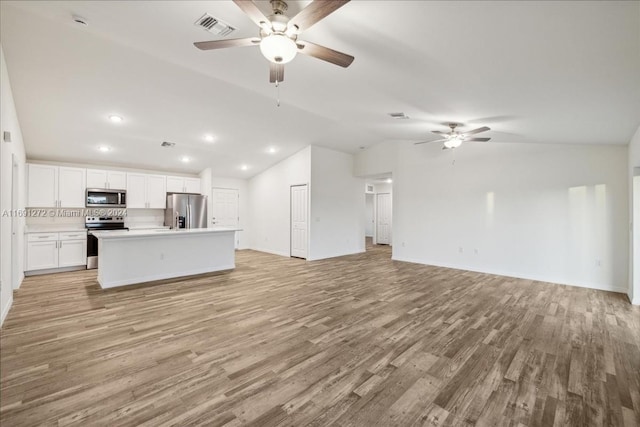 unfurnished living room featuring ceiling fan, lofted ceiling, and light hardwood / wood-style flooring