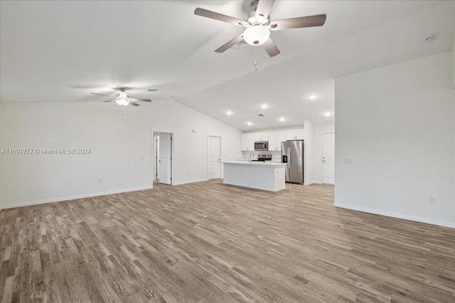 unfurnished living room featuring light wood-type flooring, vaulted ceiling, and ceiling fan