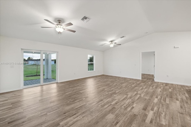 empty room with vaulted ceiling, light hardwood / wood-style flooring, and ceiling fan