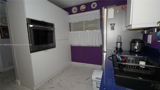 kitchen with white cabinetry and oven