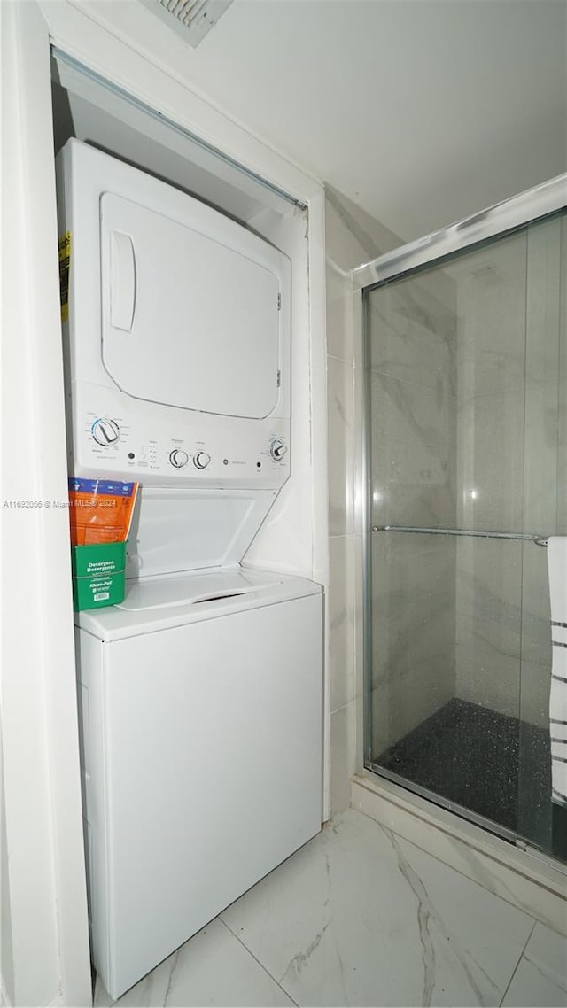 laundry room with stacked washer and dryer