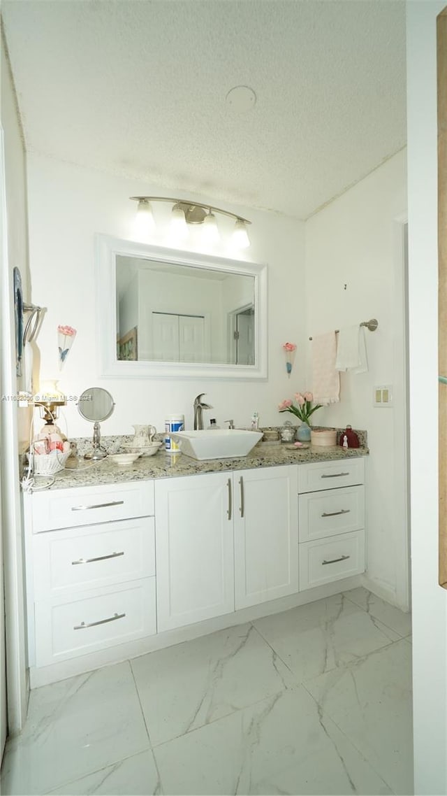 bathroom with vanity and a textured ceiling