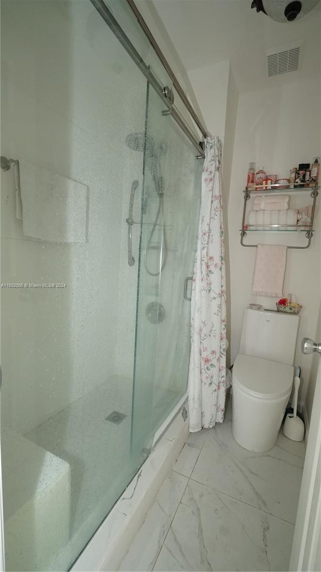 bathroom featuring walk in shower and toilet