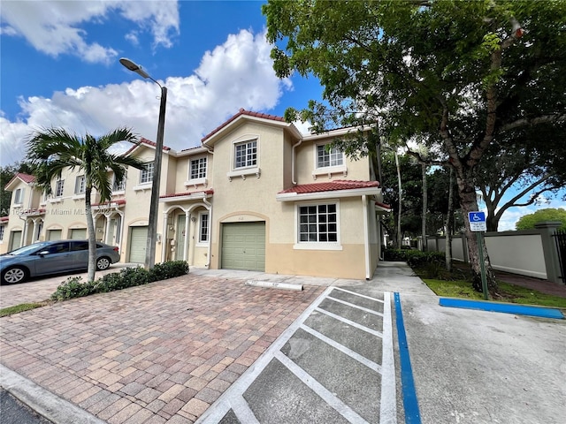 mediterranean / spanish home with a garage