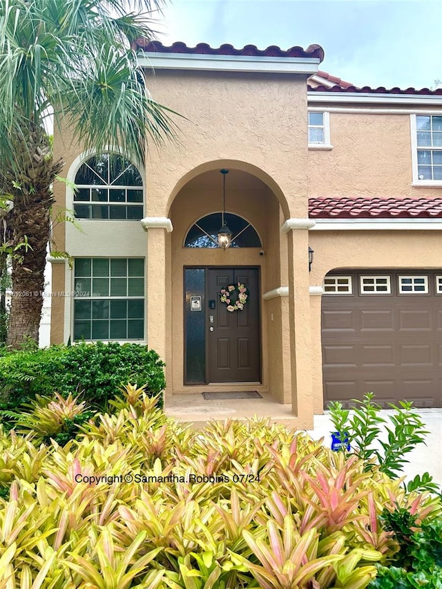 view of exterior entry featuring a garage