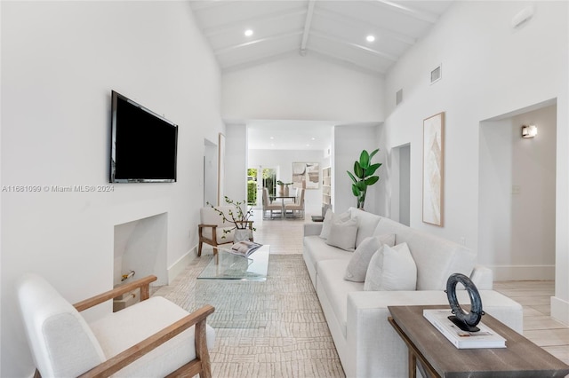 tiled living room with beamed ceiling and high vaulted ceiling