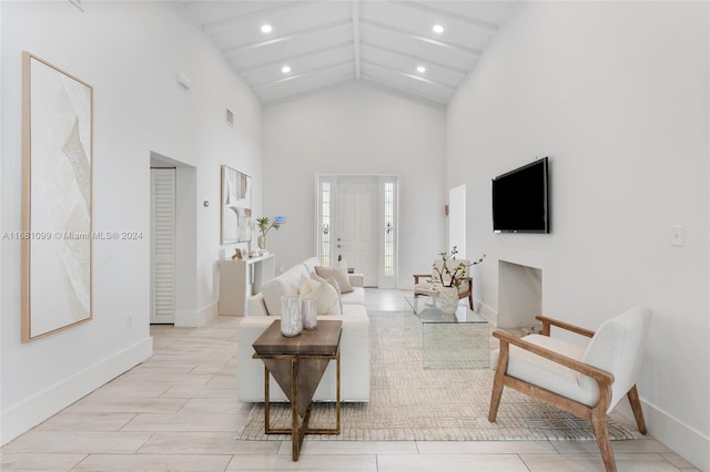 living room with light hardwood / wood-style floors and high vaulted ceiling