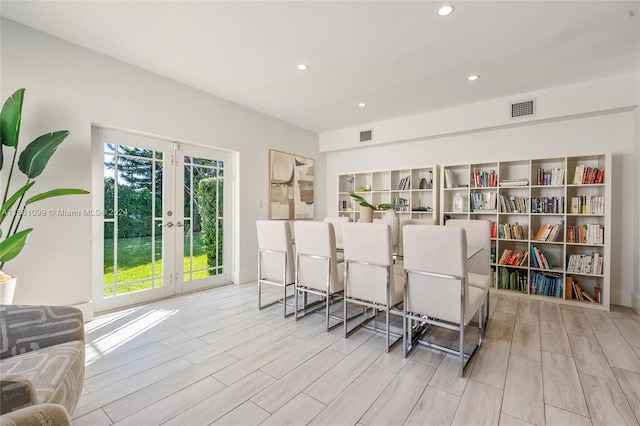 interior space with french doors and light hardwood / wood-style floors