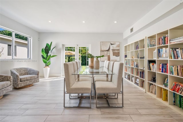 dining room featuring french doors and light hardwood / wood-style flooring