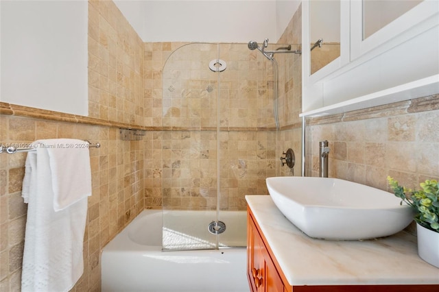 bathroom featuring vanity, tile walls, and tiled shower / bath