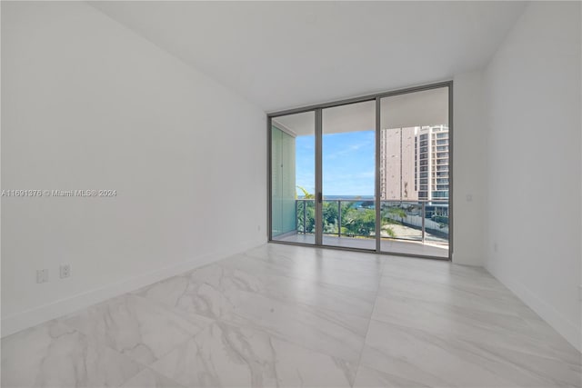 empty room featuring a wall of windows