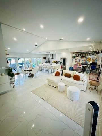 living room featuring lofted ceiling